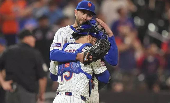 New York Mets pitcher David Peterson hugs catcher Luis Torrens after a baseball game against the Washington Nationals Wednesday, June 11, 2025, in New York. (AP Photo/Frank Franklin II)