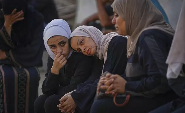 Relatives of Palestinians killed in Israeli army strikes wait for their burials at Shifa hospital in Gaza City, Thursday, June 26, 2025. (AP Photo/Jehad Alshrafi)