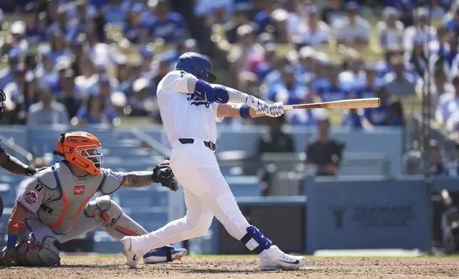 Los Angeles Dodgers' Michael Conforto (23) hits an RBI single during the eighth inning of a baseball game against the New York Mets Thursday, June 5, 2025, in Los Angeles. (AP Photo/Jae C. Hong)