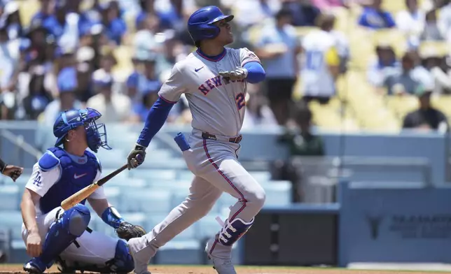 New York Mets' Juan Soto (22) watches after hitting a fly ball during the first inning of a baseball game against the Los Angeles Dodgers Thursday, June 5, 2025, in Los Angeles. (AP Photo/Jae C. Hong)