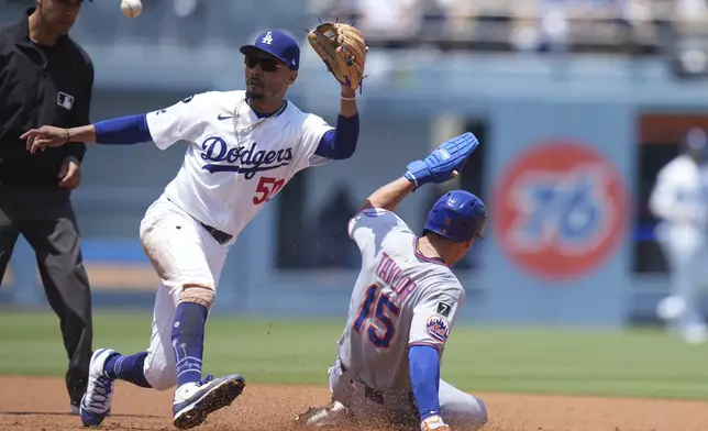 New York Mets' Tyrone Taylor (15) steals second base against Los Angeles Dodgers shortstop Mookie Betts (50) during the second inning of a baseball game Thursday, June 5, 2025, in Los Angeles. (AP Photo/Jae C. Hong)
