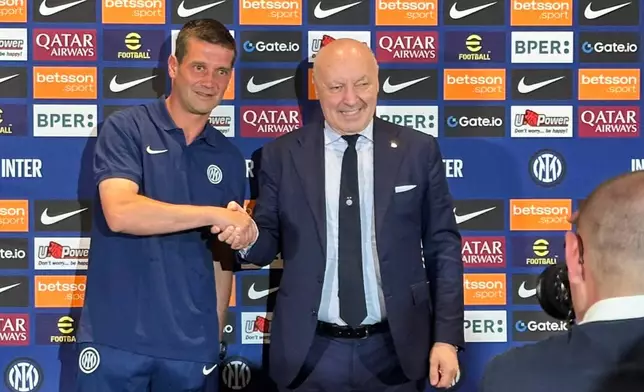 Inter Milan's new coach Cristian Chivu team president Giuseppe Marotta shake hands after Chivu's formal introduction at a soccer news conference in Los Angeles, Saturday, June 14, 2025. (AP Photo/Greg Beacham)