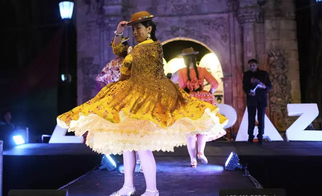 A woman competes in the Miss Cholita Pacena beauty pageant, an annual contest aiming to recognize Aymara Indigenous women's fashion and beauty, as well as their command of the Indigenous lifestyle and language, in La Paz, Bolivia, Friday, June 27, 2025. (AP Photo/Juan Karita)