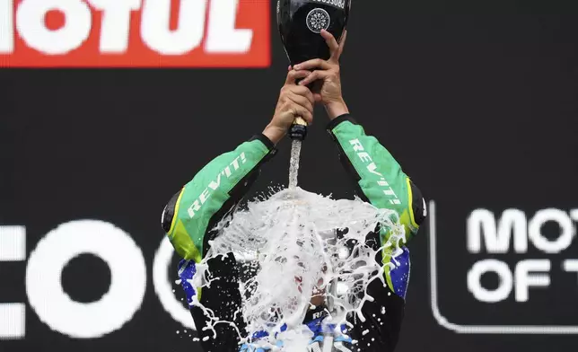 Brazil's rider Diogo Moreira of the Italtrans Racing Team celebrates on the podium after winning the Moto2 race at the Grand Prix of the Netherlands at the TT Circuit in Assen, northern Netherlands, Sunday, June 29, 2025. (AP Photo/Peter Dejong)