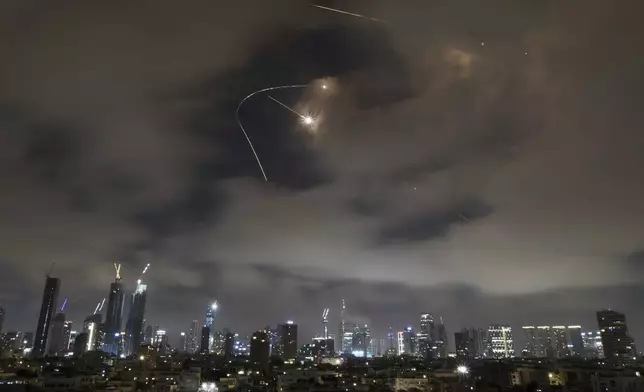 Israeli air defense system fires to intercept missiles during an Iranian attack over Tel Aviv, Israel, Saturday, June 21, 2025. (AP Photo/Leo Correa)