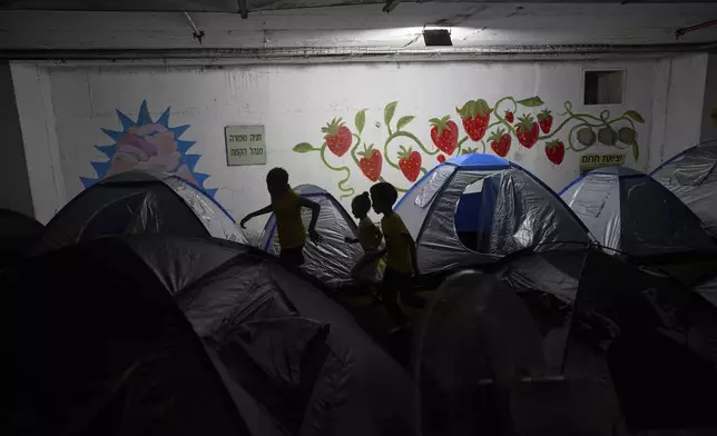 Children play in a public bomb shelter in Tel Aviv, Israel, on Saturday, June 21, 2025, amid concerns over potential Iranian missile attacks. (AP Photo/Oded Balilty)