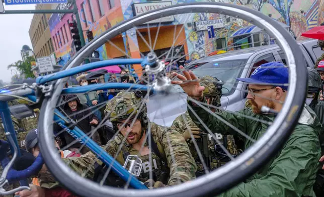 ICE, ATF, and FBI officers are seen as tensions escalate between community members and federal agents following an operation, Tuesday, June 3, 2025, in Minneapolis, Minn. (Kerem Yücel/Minnesota Public Radio via AP)