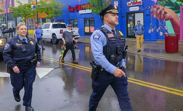 Minneapolis Police Chief Brian O'Hara walks down a street as protesters clash with federal agents on Tuesday June 3, 2025, in Minneapolis, Minn. (Kerem Yücel/Minnesota Public Radio via AP)