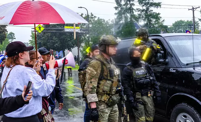 Community members protest as federal agents, including officers with the FBI and Homeland Security Investigations (HSI), conduct an operation, Tuesday, June 3, 2025, in Minneapolis, Minn. (Kerem Yücel/Minnesota Public Radio via AP)