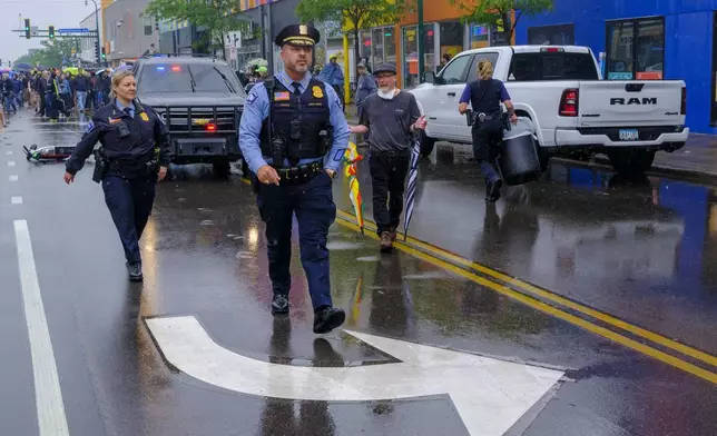 Minneapolis Police Chief Brian O'Hara walks down a street as protesters clash with federal agents on Tuesday, June 3, 2025 in Minneapolis, Minn.. (Kerem Yücel/Minnesota Public Radio via AP)