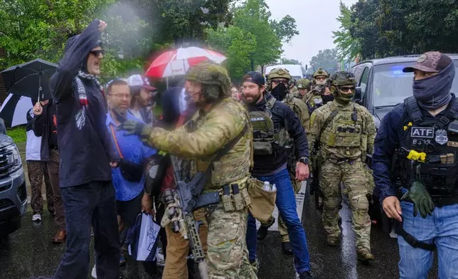 ICE, ATF, and FBI officers are seen as tensions escalate between community members and federal agents following an operation, Tuesday, June 3, 2025, in Minneapolis, Minn. (Kerem Yücel/Minnesota Public Radio via AP)