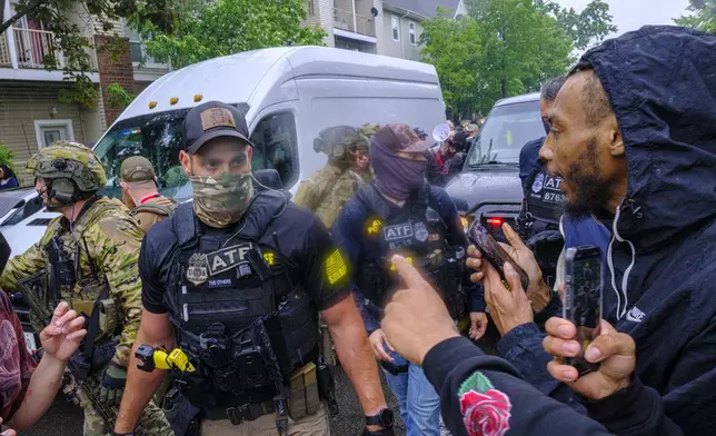 Protesters confront ICE, ATF, and FBI officers as federal agents conduct an operation in Minneapolis, on Tuesday, June 3, 2025. (Kerem Yücel/Minnesota Public Radio via AP)