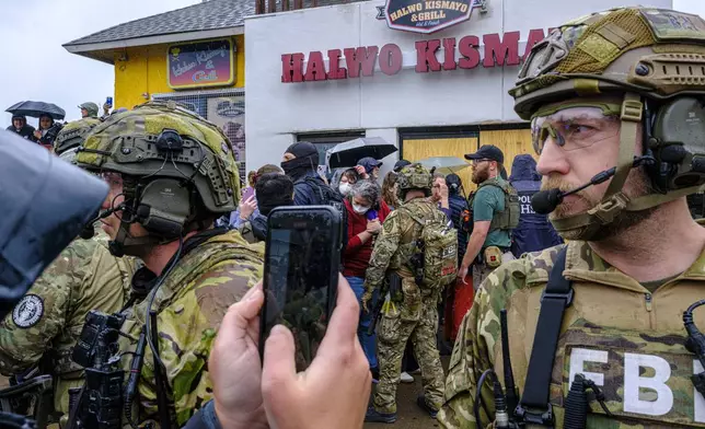 ICE, ATF, and FBI officers are confronted by protesters as federal agents conduct an operation in Minneapolis, on Tuesday, June 3, 2025. (Kerem Yücel/Minnesota Public Radio via AP)