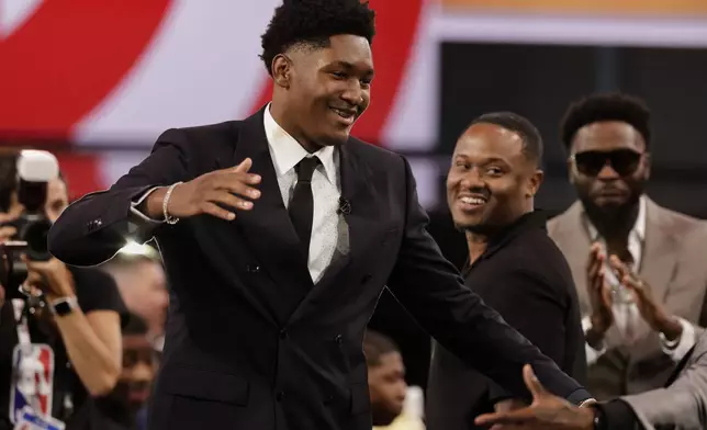 Derik Queen reacts after being selected 13th by the Atlanta Hawks in the first round of the NBA basketball draft, Wednesday, June 25, 2025, in New York. (AP Photo/Adam Hunger)