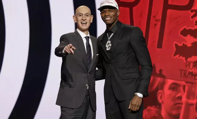 Cedric Coward poses for a photo with NBA commissioner Adam Silver after being selected 11th by the Portland Trail Blazers in the first round of the NBA basketball draft, Wednesday, June 25, 2025, in New York. (AP Photo/Adam Hunger)
