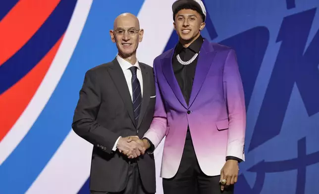 Nique Clifford poses for a photo with NBA commissioner Adam Silver after being selected 24th by the Oklahoma City Thunder in the first round of the NBA basketball draft, Wednesday, June 25, 2025, in New York. (AP Photo/Adam Hunger)