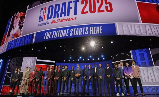 Prospective draft picks gather on stage for a photo before the first round of the NBA basketball draft, Wednesday, June 25, 2025, in New York. (AP Photo/Adam Hunger)