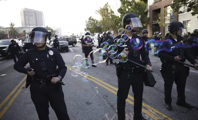 Demonstrators face off with Los Angeles Police Department officers during a protest in response to a series of United States Immigration and Customs Enforcement (ICE) raids, in Los Angeles, Calif., Monday, June 9, 2025. (Stephen Lam/San Francisco Chronicle via AP)