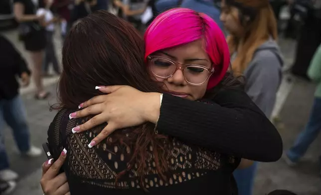 Jaslyn Hernandez, daughter of a car wash worker, is embraced during a press conference with families of detained car wash workers Wednesday, June 11, 2025, in Culver City, Calif. (AP Photo/Ethan Swope)