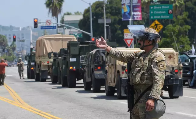 U.S. National Guard direct Tuesday, June 10, 2025, in Los Angeles. (AP Photo Damian Dovarganes)
