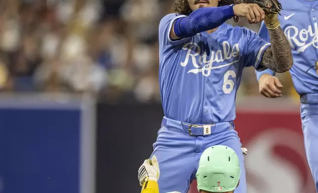 Kansas City Royals second baseman Jonathan India (6) throws to first base after forcing out San Diego Padres' Jose Iglesias (7) in the sixth inning of a baseball game, Friday, June 20, 2025, in San Diego. (AP Photo/Tony Ding)