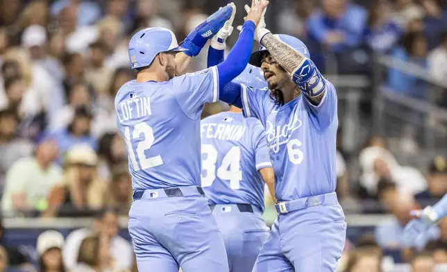 Kansas City Royals' Nick Loftin (12) celebrates after a home run by Jonathan India (6) in the fifth inning of a baseball game against the San Diego Padres, Friday, June 20, 2025, in San Diego. (AP Photo/Tony Ding)