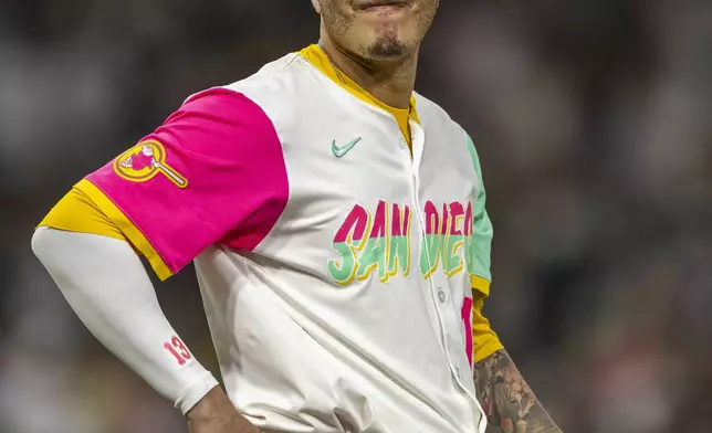 San Diego Padres' Manny Machado reacts as he waits for his fielding gear before the bottom of the sixth inning of a baseball game against the Kansas City Royals, Friday, June 20, 2025, in San Diego. (AP Photo/Tony Ding)