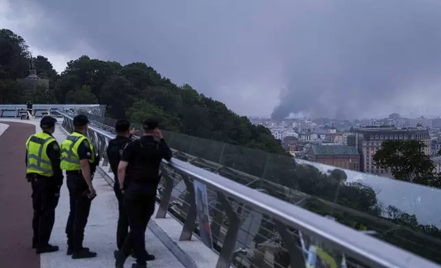 Smoke rises after Russian drone strike on Kyiv, Ukraine, Tuesday, June 10, 2025. (AP Photo/Evgeniy Maloletka)