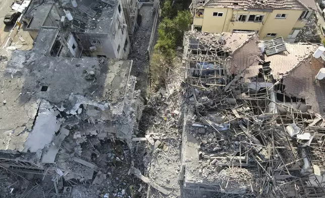 Destroyed residential buildings that was hit by a missile fired from Iran is seen in Ramat Gan, near Tel Aviv, Israel on Saturday, June 14, 2025. (AP Photo/Ariel Schalit)