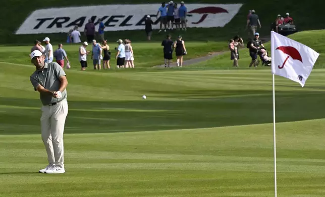 Scottie Scheffler hits his second shot on the 15th hole during the third round of the Travelers Championship golf tournament at TPC River Highlands, Saturday, June 21, 2025, in Cromwell, Conn. (AP Photo/Jessica Hill)