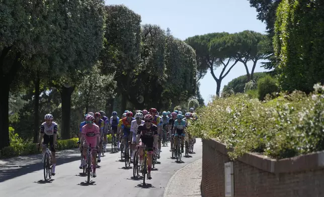 Britain's Simon Yates, center, in the pink jersey, leads the pack during a ceremonial lap inside the Vatican before the start of the final stage of the Giro d'Italia, Sunday, June 1, 2025. (AP Photo/Gregorio Borgia)
