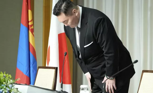 Hakuho Sho, a retired “yokozuna” or grand champion of sumo, Hakuho, bows during a press conference in Tokyo, Monday, June 9, 2025, to deliver a farewell message following the reported acceptance of his resignation. (AP Photo/Eugene Hoshiko)