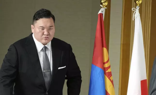 Hakuho Sho, a retired “yokozuna” or grand champion of sumo, Hakuho, walks to the venue for a press conference in Tokyo, Monday, June 9, 2025, to deliver a farewell message following the reported acceptance of his resignation. (AP Photo/Eugene Hoshiko)