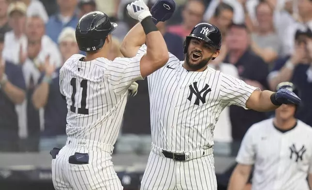 New York Yankees' Jasson Domínguez celebrates with Anthony Volpe after they scored on a two-run home run by Volpe during the first inning of a baseball game, Friday, June 6, 2025, in New York. (AP Photo/Frank Franklin II)