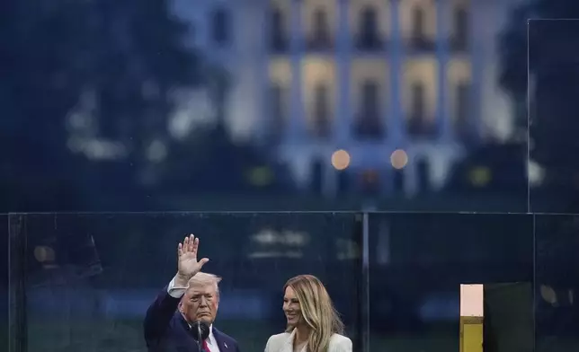 President Donald Trump and first lady Melania Trump attend a military parade commemorating the Army's 250th anniversary, coinciding with his 79th birthday, Saturday, June 14, 2025, in Washington. (AP Photo/Julia Demaree Nikhinson)