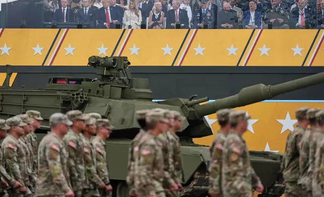 President Donald Trump, first lady Melania Trump and other guests attend a military parade commemorating the Army's 250th anniversary, coinciding with his 79th birthday, Saturday, June 14, 2025, in Washington. (AP Photo/Julia Demaree Nikhinson)