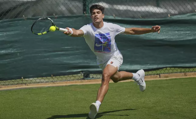 Carlos Alcaraz of Spain plays a return during a practice session ahead of the Wimbledon Championships in London, Friday, June 27, 2025. (AP Photo/Kin Cheung)