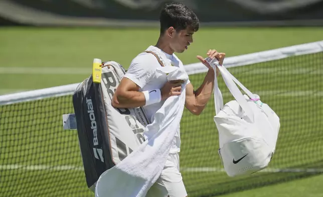 Carlos Alcaraz of Spain attends a practice session ahead of the Wimbledon Championships in London, Friday, June 27, 2025. (AP Photo/Kin Cheung)