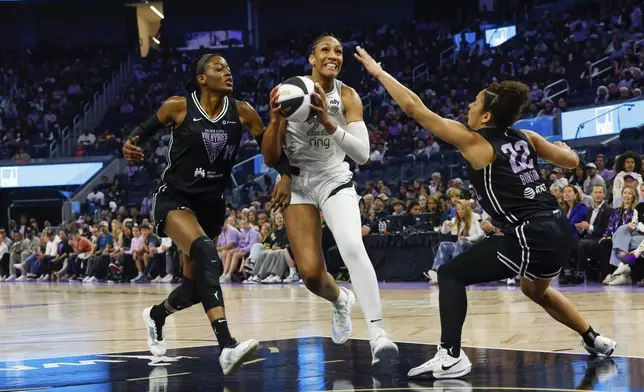 Golden State Valkyries center Temi Fagbenle (14) and guard Veronica Burton (22) defend against Las Vegas Aces center A'ja Wilson in the first half of a WNBA basketball game, Saturday, June 7, 2025, at Chase Center in San Francisco, Calif. (Yalonda M. James/San Francisco Chronicle via AP)