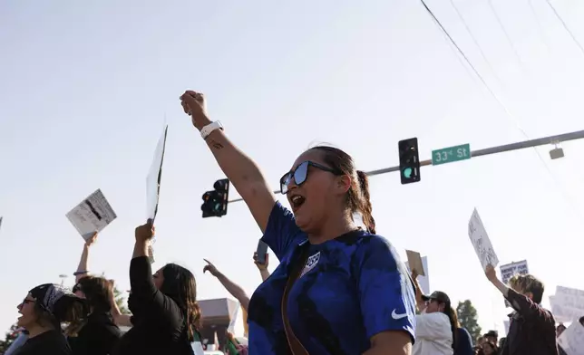 Hundreds gather in after U.S. Immigration and Customs Enforcement conducted a raid earlier in the day in Omaha, Neb. on Tuesday, June 10, 2025. (Nikos Frazier/Omaha World-Herald via AP)