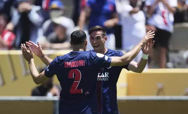 Paris Saint-Germain's Fabian Ruiz, right, celebrates after scoring the opening goal with teammate Achraf Hakimi during the Club World Cup group B soccer match between PSG and Atletico Madrid in Pasadena, Calif., Sunday, June 15, 2025. (AP Photo/Jae Hong)