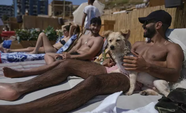 People sunbathe on the beach along the Mediterranean Sea in Batroun, northern Lebanon, May 31, 2025. (AP Photo/Bilal Hussein)