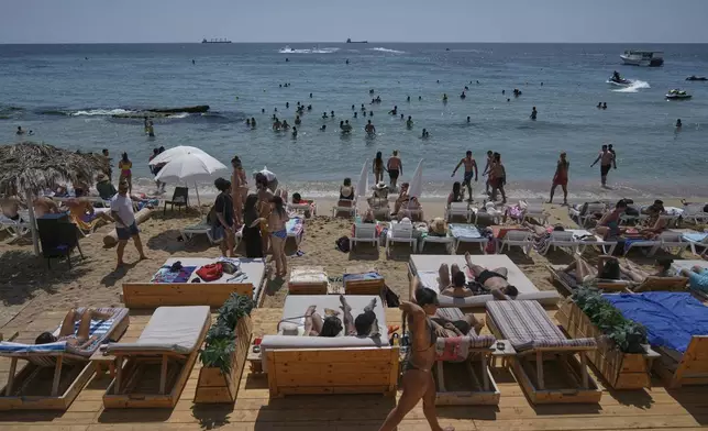 People sunbathe on the beach along the Mediterranean Sea in Batroun, northern Lebanon, May 31, 2025. (AP Photo/Bilal Hussein)