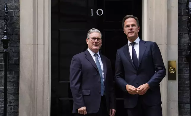 Britain's Prime Minister Sir Keir Starmer, left, welcomes Nato Secretary General Mark Rutte to Downing Street in London, Monday, June 9, 2025. (Jordan Pettitt/PA via AP)