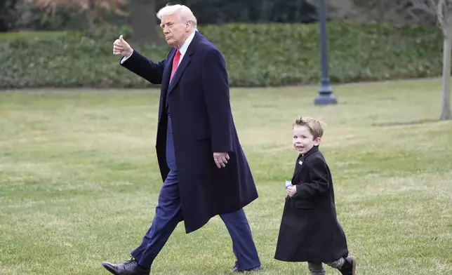 FILE - President Donald Trump walks with Elon Musk's son X Æ A-Xii on the South Lawn of the White House, March 14, 2025, in Washington to depart on Marine One. (AP Photo/Alex Brandon, File)