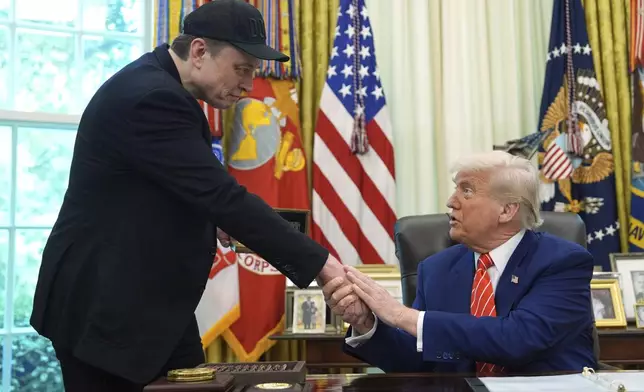 President Donald Trump, right, shakes the hand of Elon Musk during a news conference in the Oval Office of the White House, Friday, May 30, 2025, in Washington. (AP Photo/Evan Vucci)