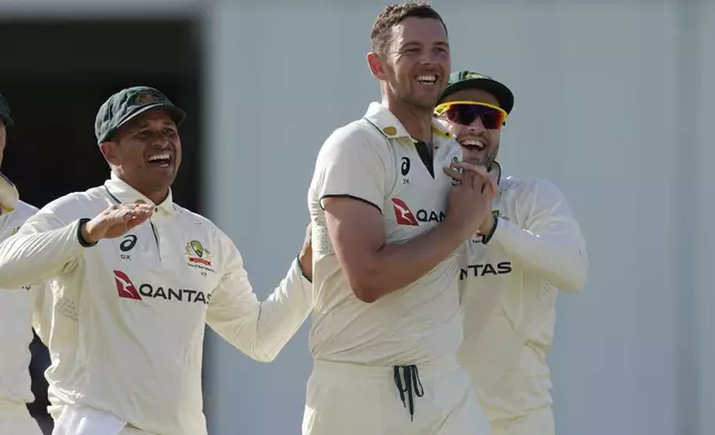 Australia's Josh Hazlewood, center, celebrates taking the wicket of West Indies' Brandon King on day three of the first cricket Test match at Kensington Stadium in Bridgetown, Barbados, Friday, June 27, 2025. (AP Photo/Ricardo Mazalan)
