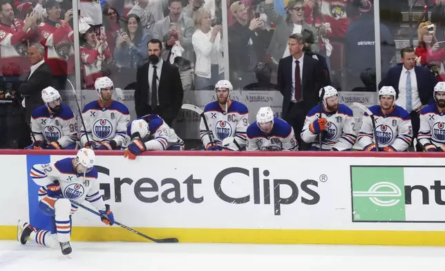 Edmonton Oilers players look on from the bench as the Florida Panthers celebrate winning the Stanley Cup following Game 6 of the NHL hockey Stanley Cup Final in Sunrise, Fla., Tuesday, June 17, 2025. (Nathan Denette/The Canadian Press via AP)