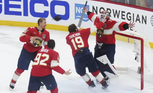 Florida Panthers goalie Sergei Bobrovsky (72), Matthew Tkachuk (19), Gustav Forsling (42) and Tomas Nosek (92) celebrate after defeating the Edmonton Oilers in Game 6 of the Stanley Cup final in Sunrise, Fla., Tuesday, June 17, 2025. (Nathan Denette/The Canadian Press via AP)
