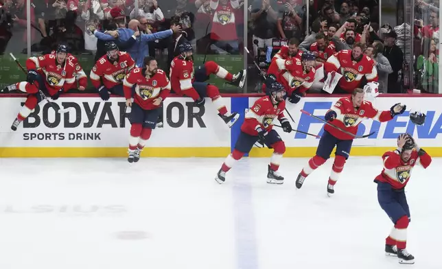 Florida Panthers players swarm the ice to celebrate after defeating the Edmonton Oilers in Game 6 of the NHL hockey Stanley Cup Final in Sunrise, Fla., Tuesday, June 17, 2025. (Nathan Denette/The Canadian Press via AP)